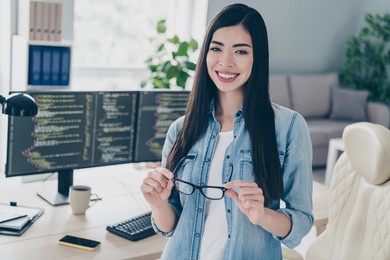 portrait of attractive cheerful intellectual girl ceo boss chief expert web designer tech engineer at work place station indoors