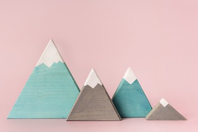 colored mountains of wood on a pink background, children's toys or decorative items