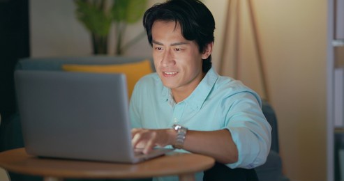 asian freelancer man use computer and work at home in the evening