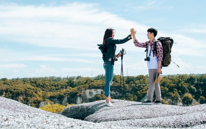 asian couple man and woman wearing casual clothes, smiling with happiness and success, adventure traveling together and hiking on the top of mountains with backpacks in summer vacation trip