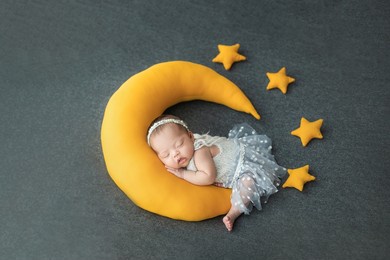 happy adorable cute asian newborn baby sleeping with moon and star shape pillow