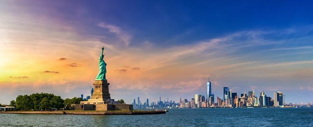 panorama of  statue of liberty against manhattan cityscape background in new york city, ny, usa