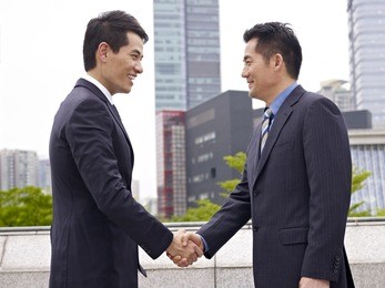 business people shaking hands.