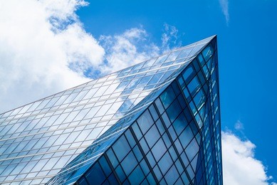 abstract photo of a modern glass building reflecting the sky