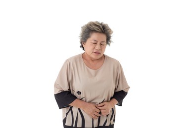 isolated cutout studio shot asian old senior sick retired gray short hair grandmother model in casual outfit standing holding hands on his tummy, stomachache on white background.