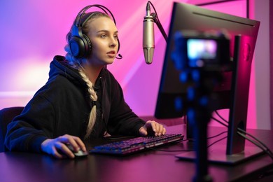 professional e-sport gamer girl streaming and plays online video game on pc