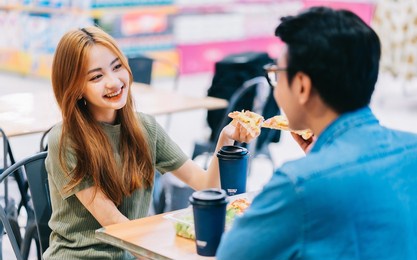young asian couple having lunch together in cafe