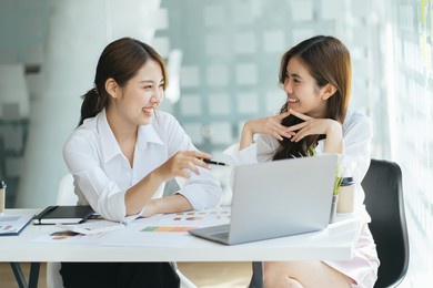 asian business adviser meeting to analyze and discuss the situation on the financial report in the meeting room.investment consultant,financial consultant,financial advisor and accounting concept