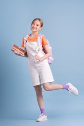 young asian student posing on blue background
