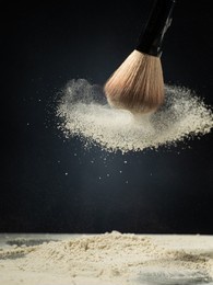 cosmetic brush and spray powder powder on a dark background