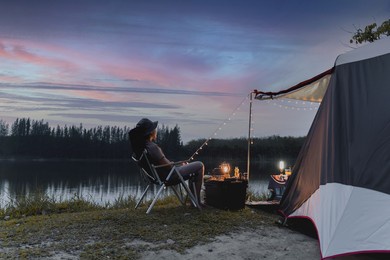 asian woman travel and camping alone at natural park in thailand. recreation and journey outdoor activity lifestyle.