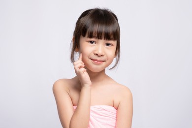asian young girl bright face on white background, skin care beauty treatments concept. white model with clean, health skin of face. children's products