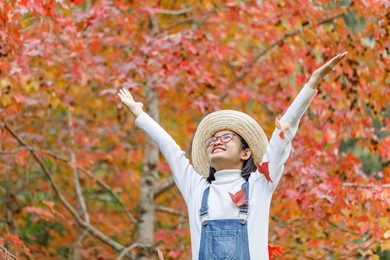 portrait happy beautiful cute asian teenage girl with glasses in autumn park