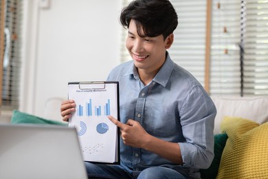 asian business man is showing the data documents for the meeting conference groups. the paper containing company financial information and plan development for brainstorming with business partners.