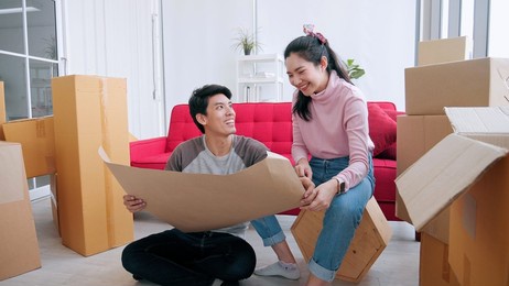 asian couple planning decoration when moving home 