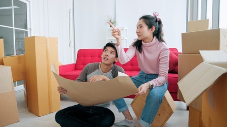 asian couple planning decoration when moving home 