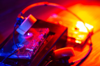 vintage cassette tape player in neon light. 90s advertisement style. disco party nostalgy concept