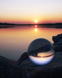 there is a ball made of glass showing the main scene up side down.