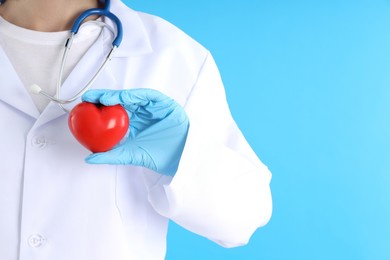 female trainee doctor with heart on blue background