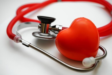 stethoscope and red heart on white background, heart health, health insurance concept