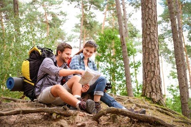 happy couple going on a hike together in a forest