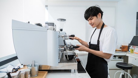startup successful small business owner sme man, handsome asia boy use coffee machine in coffee shop restaurant. portrait of asian man barista cafe owner. sme entrepreneur business seller concept