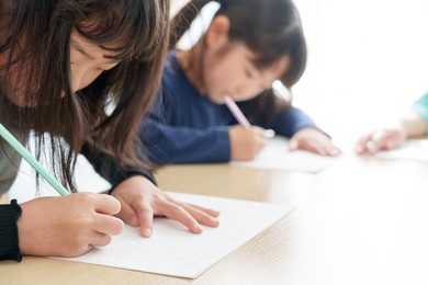 asian girls learning calligraphy at school