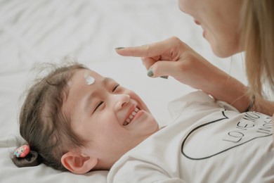 mom and daughter with organic skincare