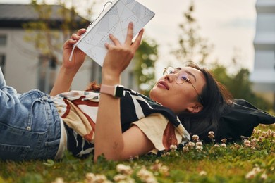 conception of education. young asian woman is outdoors at daytime.