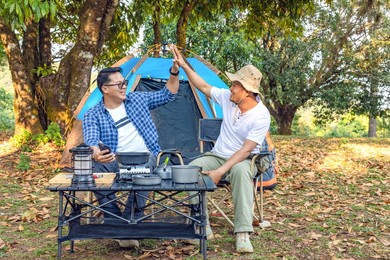 happy two hikers male relaxing with hands together giving high five feels excited.celebration and friendship concept