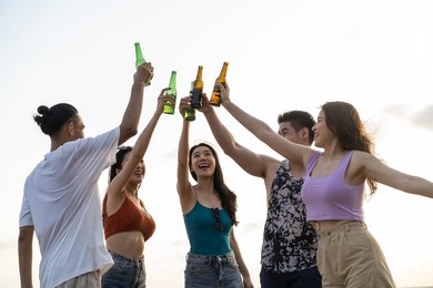 group of asian young man and woman having party on the beach together. attractive friends singing and dancing while walking and running at seaside enjoy holiday vacation trip in tropical sea island.