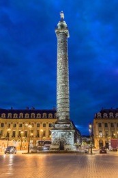 vendome column with statue of napoleon bonaparte, on the place vendome at night, in france. vendome column has 425 spiraling bas-relief bronze plates were made out of cannon.