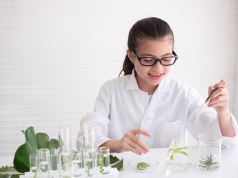 young asian girl enjoy learning and doing analysis for germs in the laboratory. science experiment. early development of children.