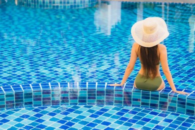 portrait beautiful young asian woman relax around swimming pool in hotel resort for leisure in vacation