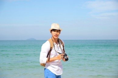 happy lifestyle asian man in sea beach, relax on the beach in summer. travel concept