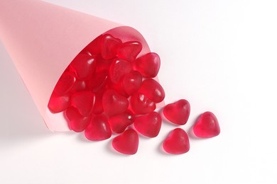 heart shaped jelly candies in a paper bag on a white background