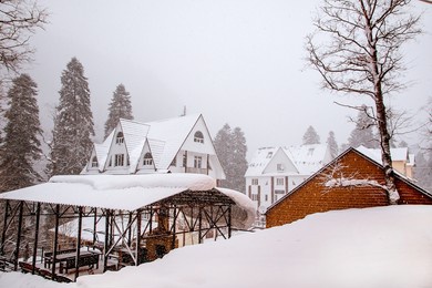 a small mountain cottage village on a winter day with snow
