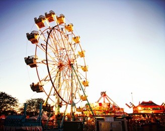 a fair ride during dusk on a warm summer evening