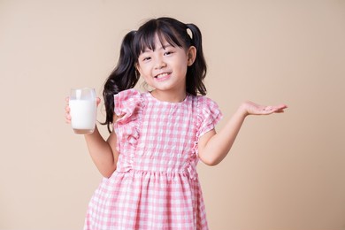 image of asian child drinking milk on background
