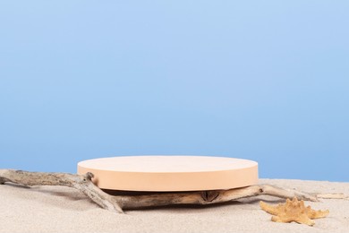 empty round beige platform podium and dry tree twigs on white beach sand background. minimal creative composition background for cosmetics or products presentation. front view
