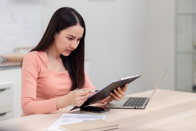 beautiful asian women are working online from home. on the desk at home using a laptop via the internet it's a new normal life of work.