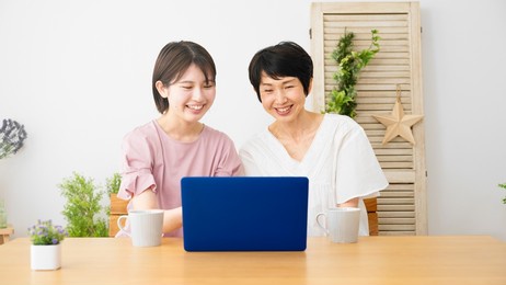 mother and daughter using laptop computer
