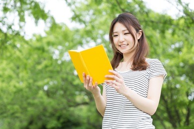 young attractive asian woman who reads a book