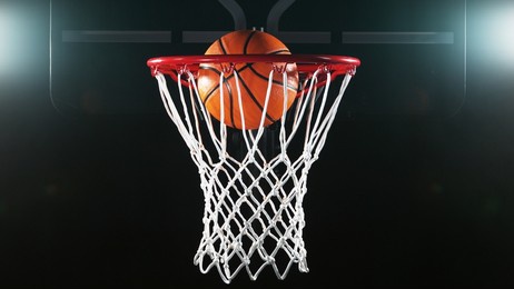 detail of basketball ball hitting the basket. isolated on black background.