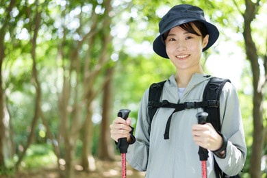 portrait of young asian woman walking in a forest