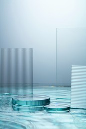 front view of transparent podium in water background
