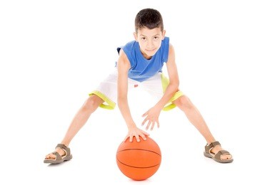 little boy with basketball isolated in white