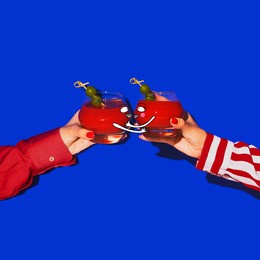 friend's party. female hands holding glass with drawings with cocktail isolated on bright blue neon background. concept of taste, alcoholic drinks. creative artwork, collage. copy space for ad, text