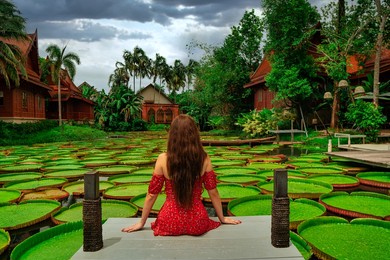 young beautiful female model sitting in iconic ma doo bua café at phuket, thailand  