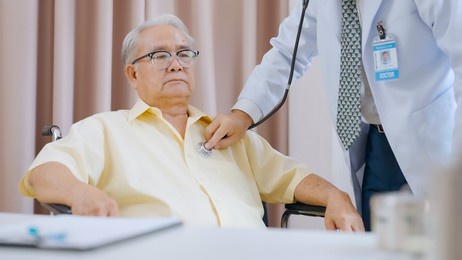 asian senior patient having medical exam with doctor in hospital. doctor listening heartbeat of male patient